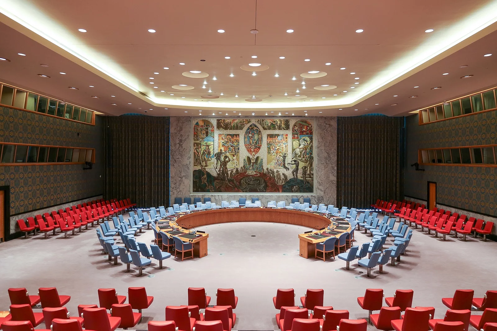 United Nations Security Council Chamber at UN Headquarters, a large conference room with a circular seating arrangement and a mural covering the back wall